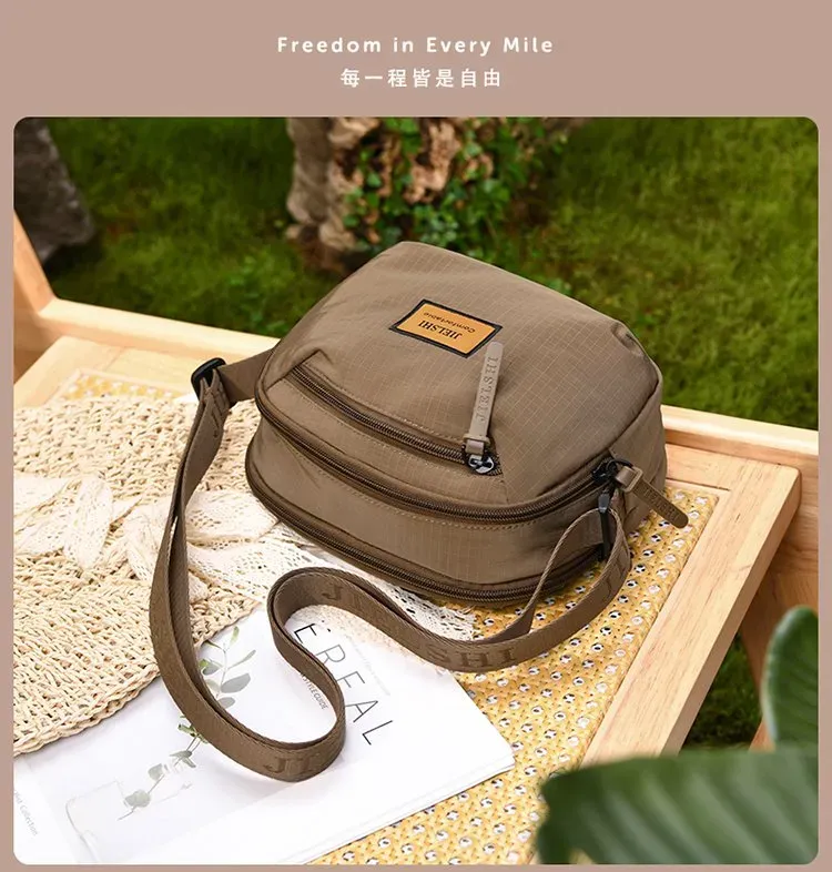 Tas Selempang Wanita Bahan Nylon Polos Bentuk Bulat Tali Panjang Resleting Grosir Import