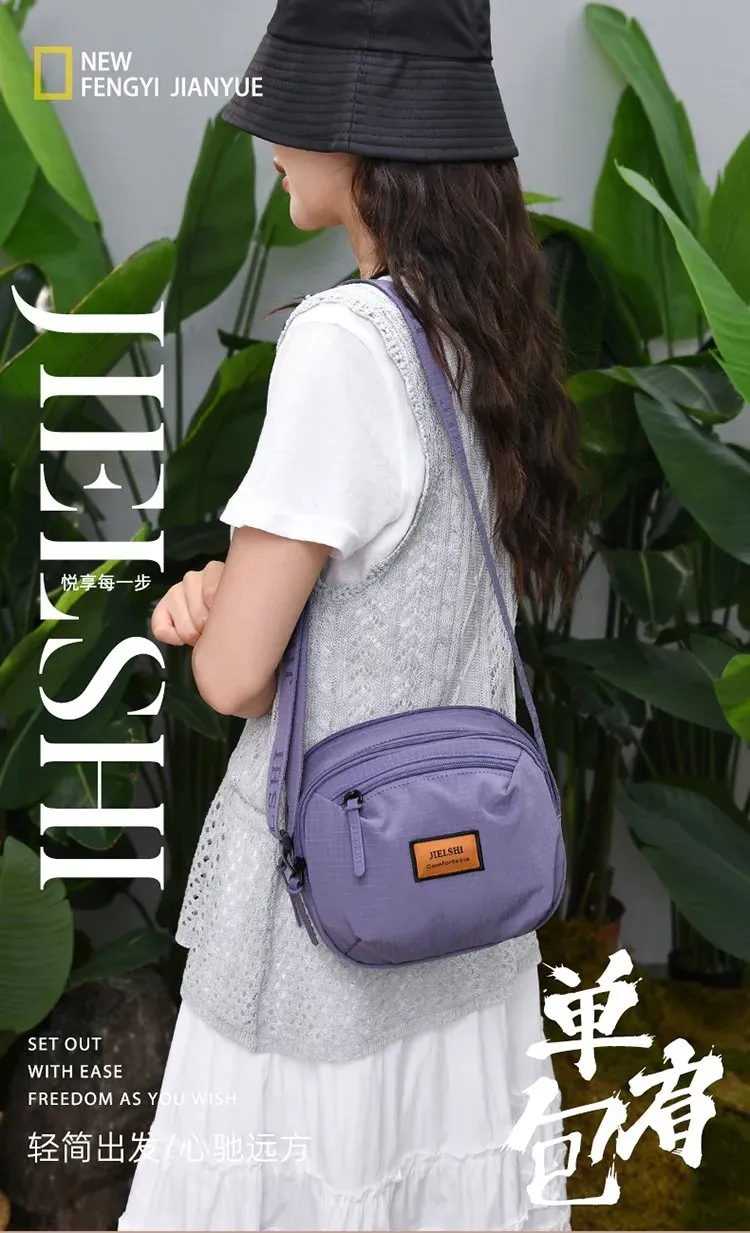 Tas Selempang Wanita Bahan Nylon Polos Bentuk Bulat Tali Panjang Resleting Grosir Import