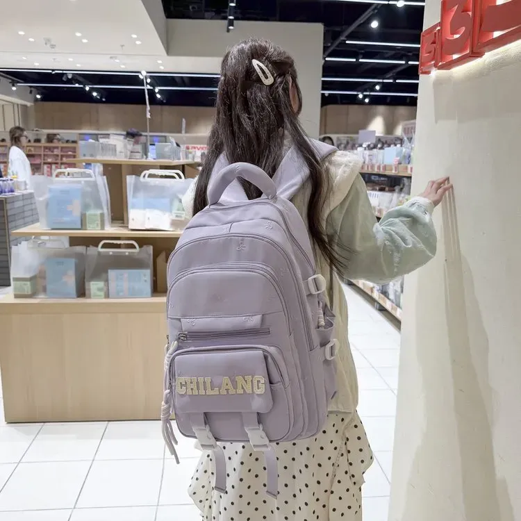 Tas Ransel Wanita Bahan Nylon Polos Warna Ungu Bentuk Kotak Tali Lebar Resleting Motif Floral